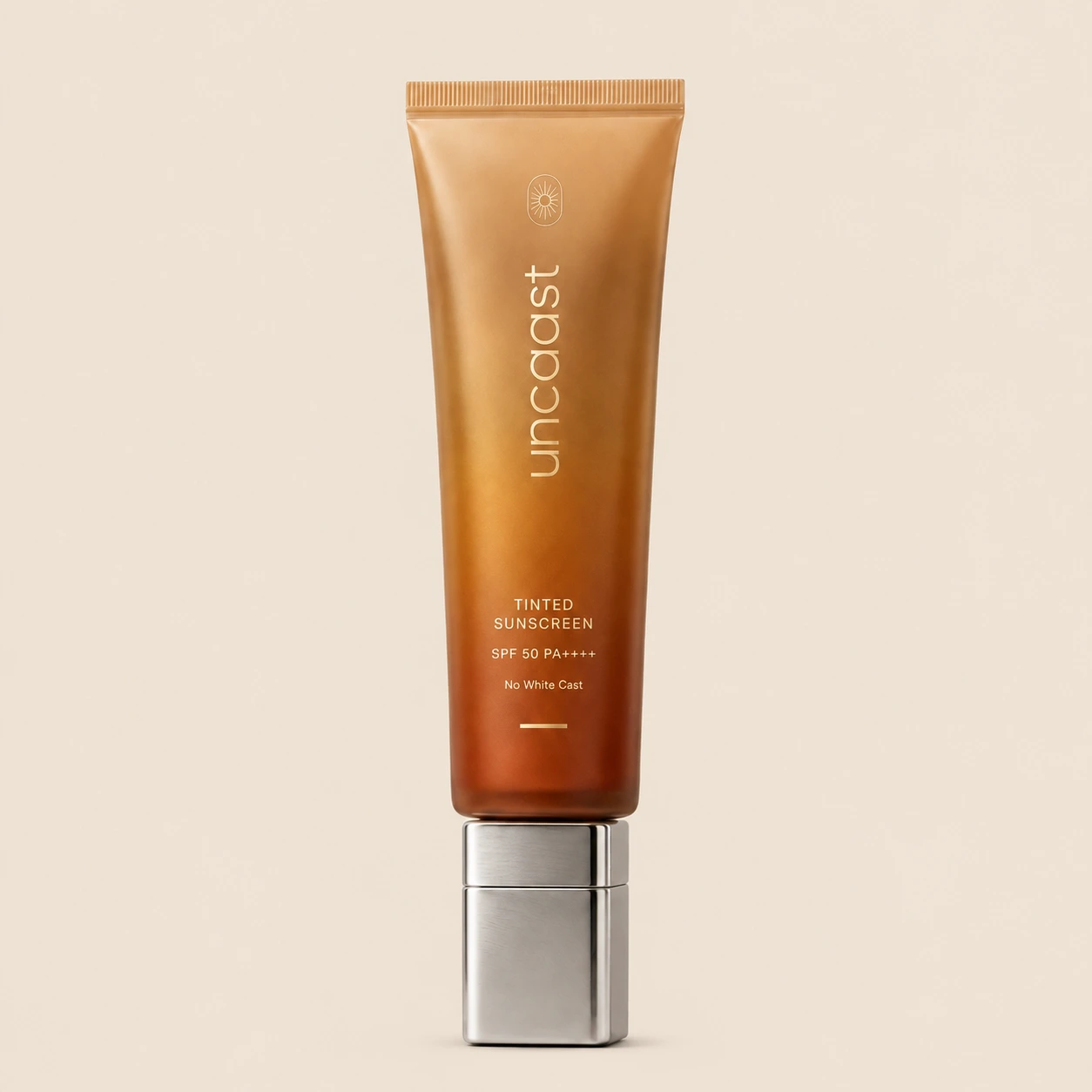 uncaast tinted sunscreen SPF 50 PA++++ tube on a plain studio background